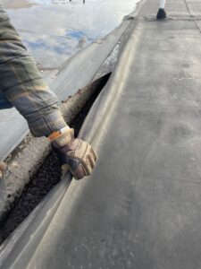 Showing water underneath the rubber roof.