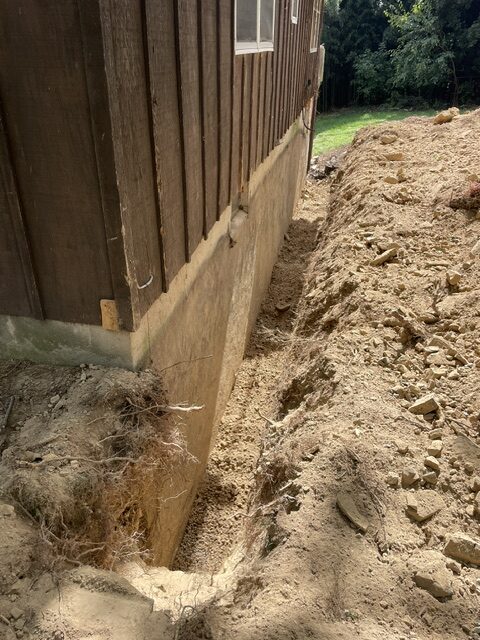 Exterior dirt removed to repair foundation crack.