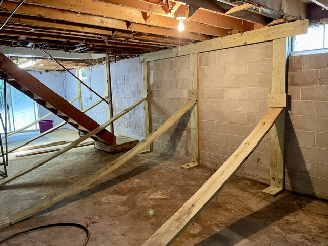 Braces supporting a bulging foundation wall.