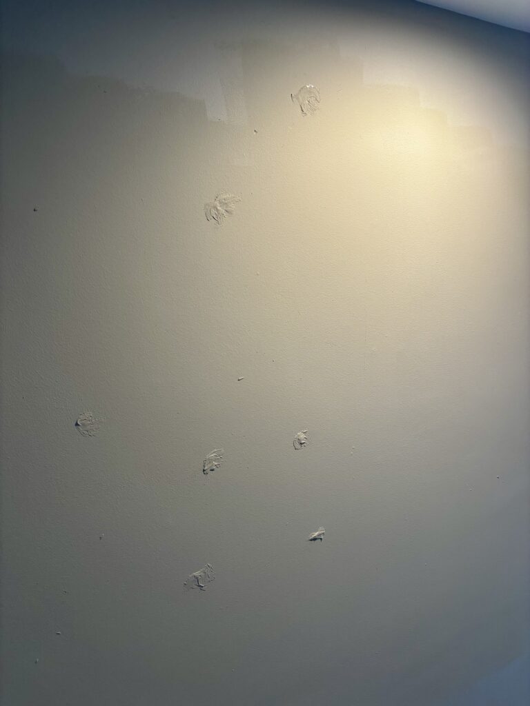Poorly patched walls with mismatched paint