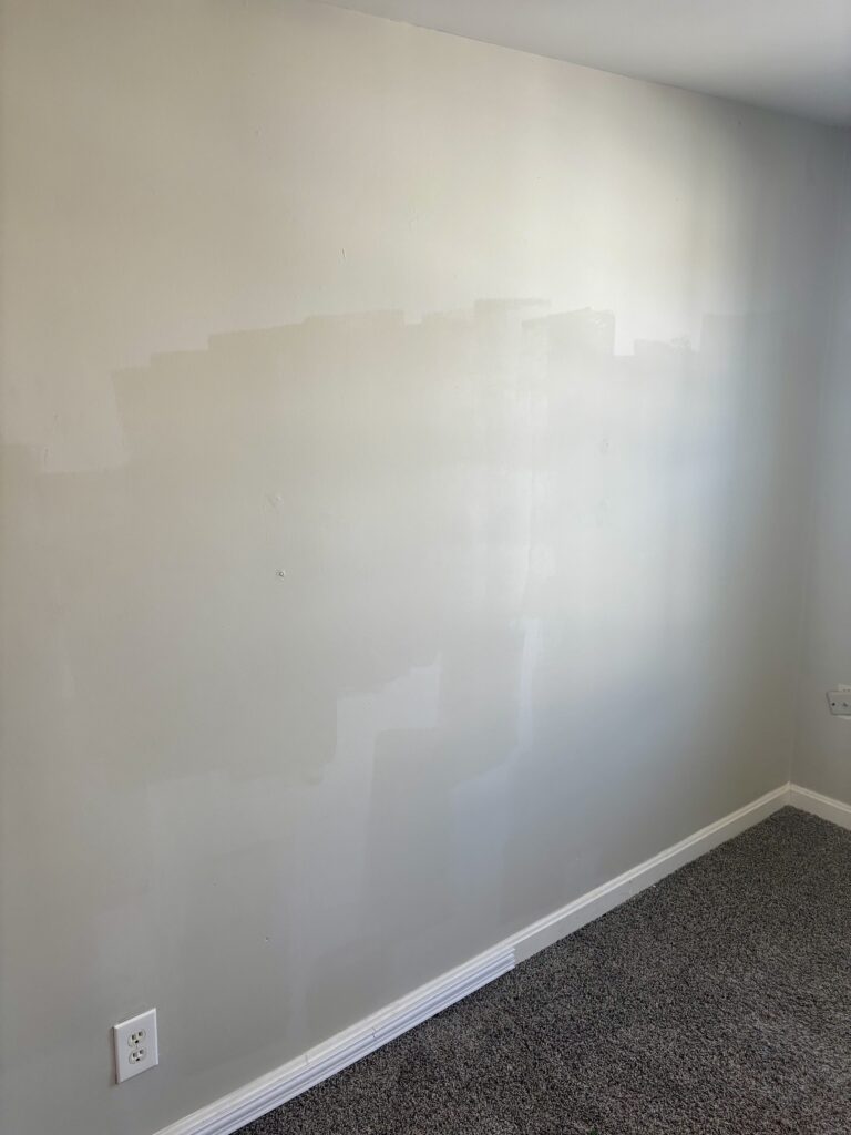 Mismatched paint rolled on rental property walls